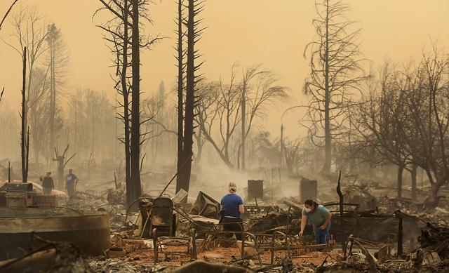 Residents of the Coffey Park neighbourhood sift through a relatives home that was torched, Monday, Oct. 9, 2017 in Santa Rosa. (AP) Residents of the Coffey Park neighbourhood sift through a relatives home that was torched, Monday, Oct. 9, 2017 in Santa Rosa. (AP)
