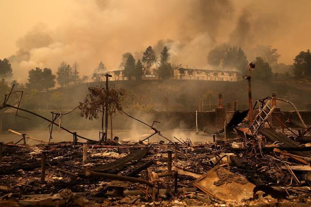 Smoke continues to rise from the Hilton Sonoma Wine Country on October 9, 2017 in Santa Rosa, California. (AFP) Smoke continues to rise from the Hilton Sonoma Wine Country on October 9, 2017 in Santa Rosa, California. (AFP)