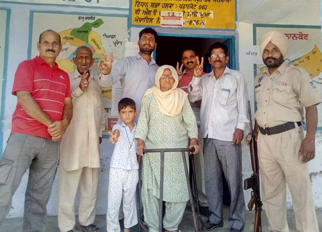 An elderly voter with family and other voters at Chak Minhasa in Sujanpur under the Gurdaspur parliamentary segment on Wednesday, October 11. (HT Photo) An elderly voter with family and other voters at Chak Minhasa in Sujanpur under the Gurdaspur parliamentary segment on Wednesday, October 11. (HT Photo)