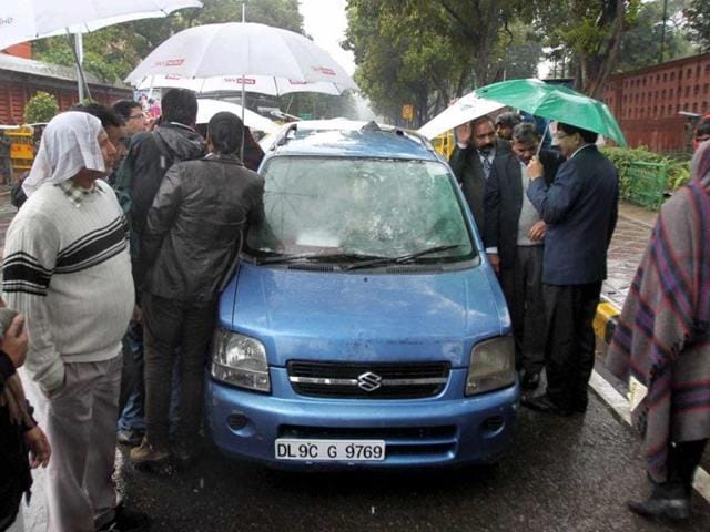 Delhi chief minister Arvind Kejriwal takes shelter in his blue Wagon R as it rains on the second day of his dharna near Rail Bhavan in New Delhi on September 9, 2014. (PT File Photo) Delhi chief minister Arvind Kejriwal takes shelter in his blue Wagon R as it rains on the second day of his dharna near Rail Bhavan in New Delhi on September 9, 2014. (PT File Photo)