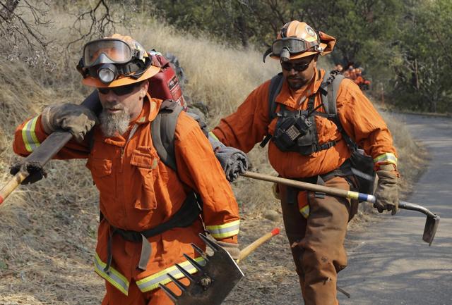 Prisoners from the McCain inmate crew from San Diego, Calif., walk on a back country road prior to clearing brush on Wednesday, Oct. 11, 2017, in Calistoga, Calif. (AP) Prisoners from the McCain inmate crew from San Diego, Calif., walk on a back country road prior to clearing brush on Wednesday, Oct. 11, 2017, in Calistoga, Calif. (AP)