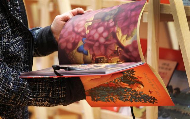 A visitor looks through a children’s book at the Frankfurt Book Fair 2017. (AFP) A visitor looks through a children’s book at the Frankfurt Book Fair 2017. (AFP)