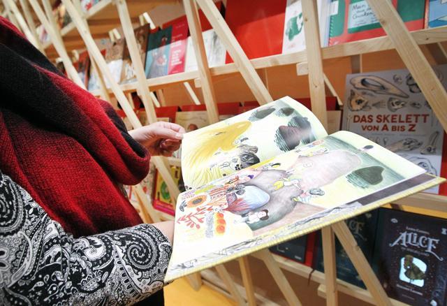 A visitor with a children’s book at the Frankfurt Book Fair 2017. (AFP) A visitor with a children’s book at the Frankfurt Book Fair 2017. (AFP)