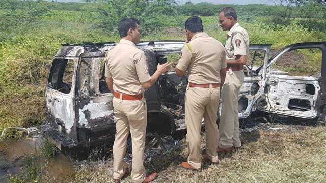 Police inspect the vehicle which was burned down by locals in Baramati. (HT PHOTO)