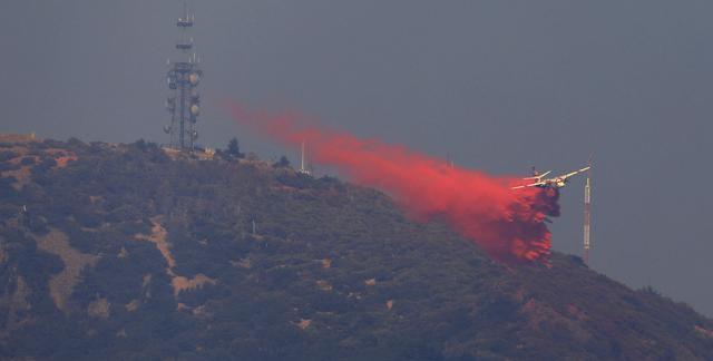 A Cal Fire tanker is used to create a retardant box on the north peak of Mt. St. Helena, Friday, October 13 to protect critical communication infrastructure. (AP Photo) A Cal Fire tanker is used to create a retardant box on the north peak of Mt. St. Helena, Friday, October 13 to protect critical communication infrastructure. (AP Photo)