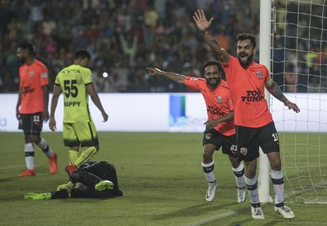 Virat Kohli celebrates after his team scored in the charity football match. (Satish Bate/HT Photo)