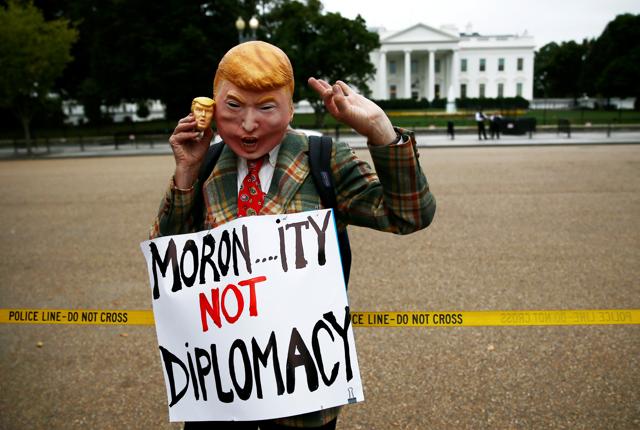 A lone protestor demonstrates outside the White House wearing a Donald Trump mask in opposition to President Trump's announcement about the Iran nuclear deal and his policy towards Iran at the White House in Washington. (REUTERS) A lone protestor demonstrates outside the White House wearing a Donald Trump mask in opposition to President Trump's announcement about the Iran nuclear deal and his policy towards Iran at the White House in Washington. (REUTERS)