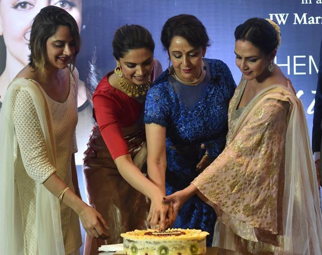 Actress and BJP MP Hema Malini along with her daughters Ahana and Esha cutting a cake to celebrate her birthday in Mumbai on Monday. Actress Deepika Padukone is also seen. (PTI) Actress and BJP MP Hema Malini along with her daughters Ahana and Esha cutting a cake to celebrate her birthday in Mumbai on Monday. Actress Deepika Padukone is also seen. (PTI)