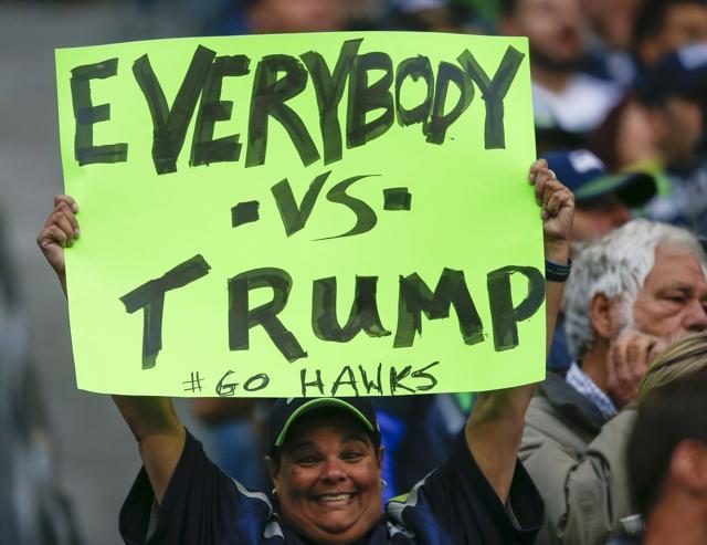 A woman holds an "Everybody vs Trump" sign in the first quarter of the game at CenturyLink Field on October 1, 2017 in Seattle, Washington. (AFP) A woman holds an "Everybody vs Trump" sign in the first quarter of the game at CenturyLink Field on October 1, 2017 in Seattle, Washington. (AFP)
