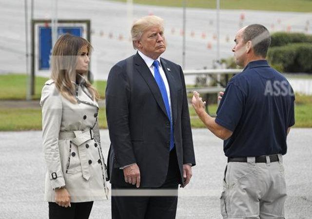 A United States Secret Service agent speaks with US President Donald Trump and first lady Melania Trump in Beltsville on October 13. (Associated Press) A United States Secret Service agent speaks with US President Donald Trump and first lady Melania Trump in Beltsville on October 13. (Associated Press)