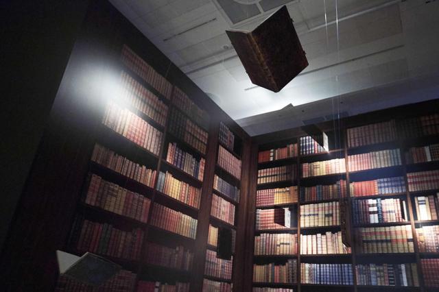 Books are suspended from the ceiling of a mock library at the exhibition. (AFP) Books are suspended from the ceiling of a mock library at the exhibition. (AFP)