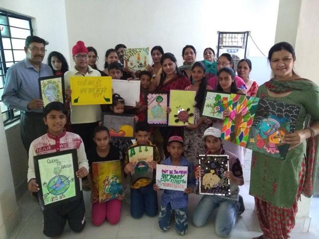 Children show posters painted to create awareness about clean environment. Children show posters painted to create awareness about clean environment.