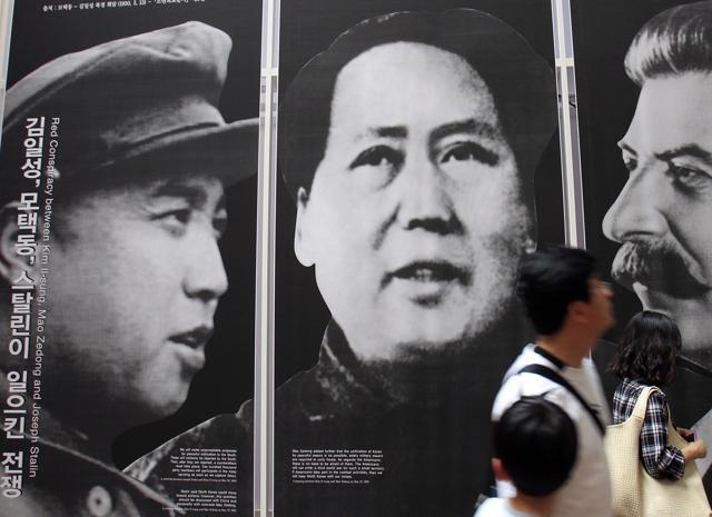 Visitors look at posters of the late leaders, from left, of North Korea's Kim Il Song, China's Mao Zedong and Russia's Joseph Stalin at a Korean War exhibition in Seoul, South Korea. (AP Photo) Visitors look at posters of the late leaders, from left, of North Korea's Kim Il Song, China's Mao Zedong and Russia's Joseph Stalin at a Korean War exhibition in Seoul, South Korea. (AP Photo)