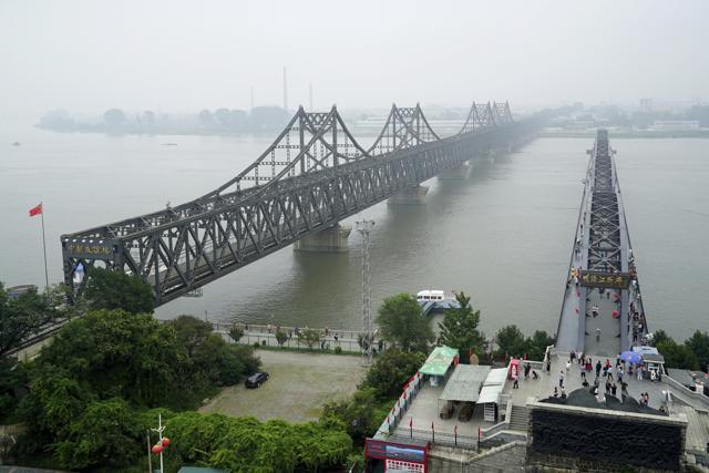 Visitors walk across the Yalu River Broken Bridge, right, next to the Friendship Bridge connecting China and North Korea in Dandong in northeastern China's Liaoning province. (AP File Photo) Visitors walk across the Yalu River Broken Bridge, right, next to the Friendship Bridge connecting China and North Korea in Dandong in northeastern China's Liaoning province. (AP File Photo)