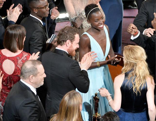 (FILES) This file photo taken on March 2, 2014 shows cast and crew of Best Picture winner 12 Years A Slave, actor Lupita Nyong'o (C), director Steve McQueen (R), actor and producer Brad Pitt (Rear R), actor Chiwetel Ejiofor (Behind Pitt), actor Angelina Jolie (Rear C), actors John Travolta (C-L), Kevin Spacey (L), Benedict Cumberbatch (Rear L), Michael Fassbender (Front C) and producer Harvey Weinstein (Front L) celebrate the film's win during the Oscars at the Dolby Theatre in Hollywood, California. (AFP) (FILES) This file photo taken on March 2, 2014 shows cast and crew of Best Picture winner 12 Years A Slave, actor Lupita Nyong'o (C), director Steve McQueen (R), actor and producer Brad Pitt (Rear R), actor Chiwetel Ejiofor (Behind Pitt), actor Angelina Jolie (Rear C), actors John Travolta (C-L), Kevin Spacey (L), Benedict Cumberbatch (Rear L), Michael Fassbender (Front C) and producer Harvey Weinstein (Front L) celebrate the film's win during the Oscars at the Dolby Theatre in Hollywood, California. (AFP)