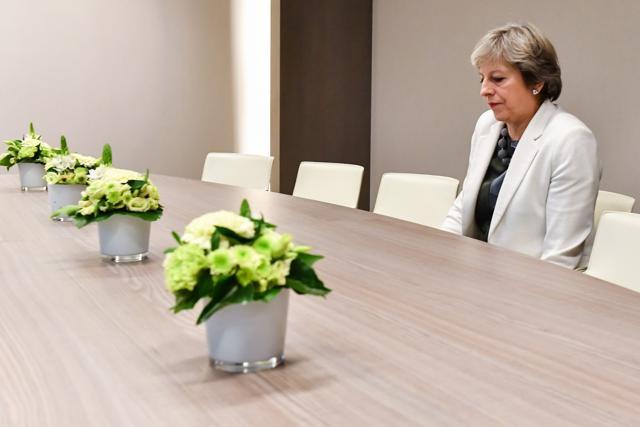 Theresa May takes a seat as she arrives for a bilateral meeting with European Council President Donald Tusk during an EU summit in Brussels on October 20, 2017. (AFP Photo)