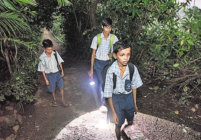 Children in the forest travel to school. They have been instructed to walk only in groups of six. (Satish Bate/HT Photo) Children in the forest travel to school. They have been instructed to walk only in groups of six. (Satish Bate/HT Photo)