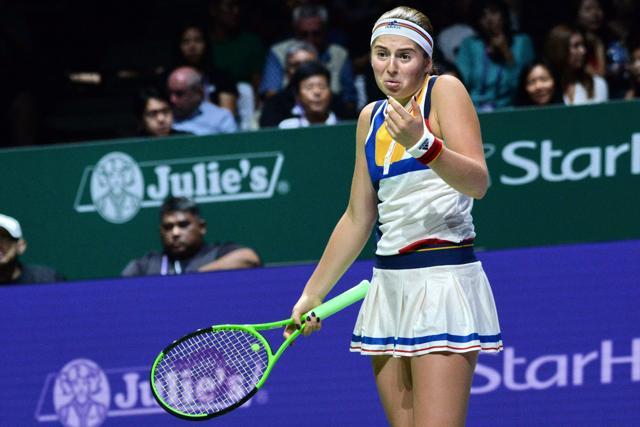 Jelena Ostapenko of Latvia reacts on a point against Garbine Muguruza of Spain during the WTA Finals tennis tournament in Singapore. (AFP)