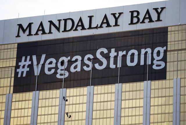 In this Monday, October 16, 2017, file photo, workers install a #VegasStrong banner on the Mandalay Bay hotel and casino in Las Vegas. Stephen Paddock opened fire from the hotel on an outdoor country music concert, killing 58 and injuring hundreds. (AP Photo) In this Monday, October 16, 2017, file photo, workers install a #VegasStrong banner on the Mandalay Bay hotel and casino in Las Vegas. Stephen Paddock opened fire from the hotel on an outdoor country music concert, killing 58 and injuring hundreds. (AP Photo)