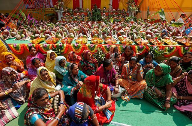 Devotees sing religious songs as they wait to collect free material to perform prayers ahead of the Hindu religious festival of Chhat Puja in Kolkata, India. (REUTERS) Devotees sing religious songs as they wait to collect free material to perform prayers ahead of the Hindu religious festival of Chhat Puja in Kolkata, India. (REUTERS)
