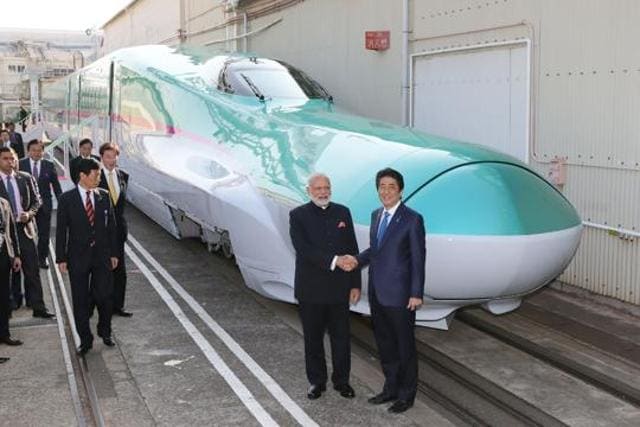 Prime Minister Narendra Modi and his Japanese counterpart Shinzo Abe (right) shake hands in front of a Shinkansen train during their inspection of a bullet train manufacturing plant in Kobe, Japan. (AFP File Photo) Prime Minister Narendra Modi and his Japanese counterpart Shinzo Abe (right) shake hands in front of a Shinkansen train during their inspection of a bullet train manufacturing plant in Kobe, Japan. (AFP File Photo)