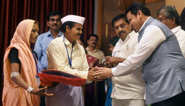Maharashtra Chief Minister Devendra Fadnavis handing over loan waiver certificates to the beneficiary farmers at a special function in Mumbai on Wednesday. (PTI) Maharashtra Chief Minister Devendra Fadnavis handing over loan waiver certificates to the beneficiary farmers at a special function in Mumbai on Wednesday. (PTI)