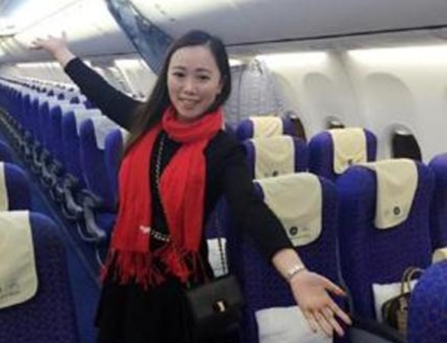 Zhang poses on an empty flight from Wuhan to Guangzhou, after the China Southern flight was delayed for 10 hours. (AFP Photo)