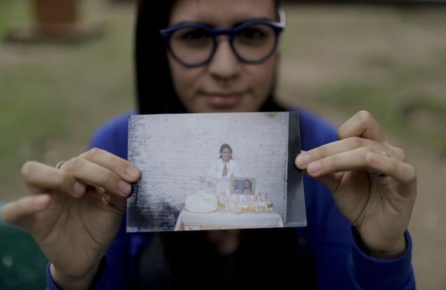 In this Oct. 11, 2017 photo, Karen Maydana, 22, shows a picture of herself as a child celebrating her first Holy Communion in Caseros, in the province of Buenos Aires, Argentina. (AP) In this Oct. 11, 2017 photo, Karen Maydana, 22, shows a picture of herself as a child celebrating her first Holy Communion in Caseros, in the province of Buenos Aires, Argentina. (AP)