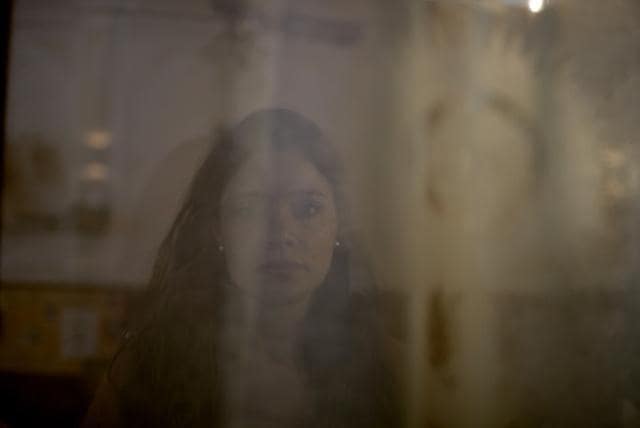In this Oct. 11, 2017 photo, Mailin Gobbo, 29, poses for a photo taken through a curtained window at San Jose Obrero church where Catholic priest Carlos Jose officiated Mass in Caseros, in the province of Buenos Aires, Argentina. (AP) In this Oct. 11, 2017 photo, Mailin Gobbo, 29, poses for a photo taken through a curtained window at San Jose Obrero church where Catholic priest Carlos Jose officiated Mass in Caseros, in the province of Buenos Aires, Argentina. (AP)