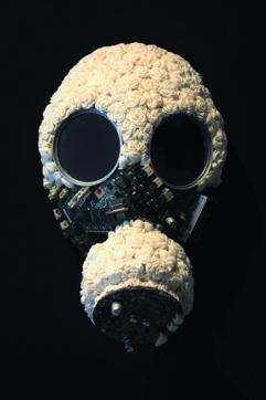 A metal helmet and a gas mask are covered in delicate shola flowers, usually used for weddings, in Dhaka-based artist Promotesh Das Pulak’s installation, Encapsulated 4. A metal helmet and a gas mask are covered in delicate shola flowers, usually used for weddings, in Dhaka-based artist Promotesh Das Pulak’s installation, Encapsulated 4.