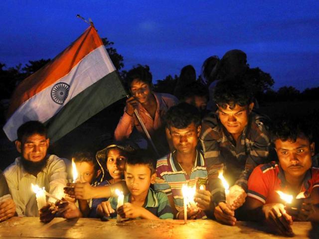 File picture of villagers of dwellers of Madhya Mashaldanga enclave in Cooch Behar district lighting candles during the exchange of enclaves between India and Bangladesh at midnight of July 31, 2015. (HT Photo) File picture of villagers of dwellers of Madhya Mashaldanga enclave in Cooch Behar district lighting candles during the exchange of enclaves between India and Bangladesh at midnight of July 31, 2015. (HT Photo)
