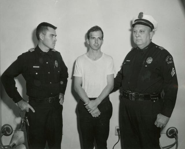 Lee Harvey Oswald, accused of assassinating former John F Kennedy, is pictured with Dallas police Sgt. Warren (right) and a fellow officer in Dallas. (Reuters File Photo) Lee Harvey Oswald, accused of assassinating former John F Kennedy, is pictured with Dallas police Sgt. Warren (right) and a fellow officer in Dallas. (Reuters File Photo)
