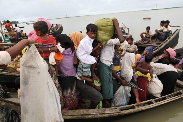 Rohingya refugees who arrived from Myanmar by boat, get into another boat to go to the main land, in Teknaf, Bangladesh, on October 7. (REUTERS) Rohingya refugees who arrived from Myanmar by boat, get into another boat to go to the main land, in Teknaf, Bangladesh, on October 7. (REUTERS)