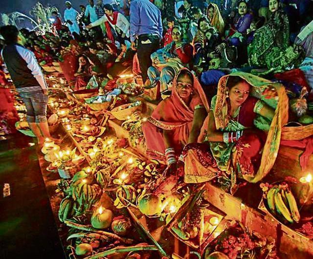 Devotees offering prayers to the rising sun on the last day of Chhath Puja at the Sector-42 lake in Chandigarh on Friday. (Reuters)
