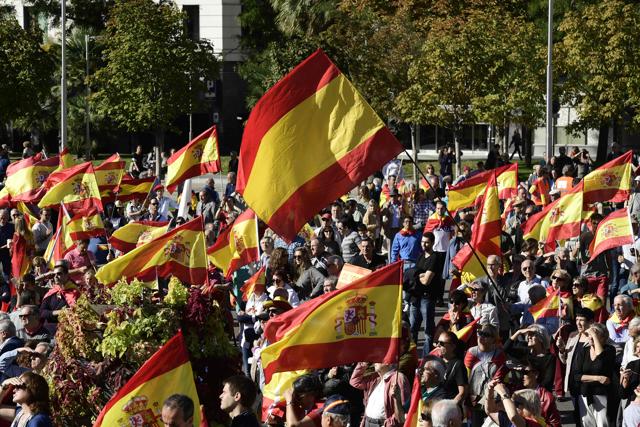 People wave Spanish flags during a demonstration calling for unity at Plaza de Colon in Madrid on October 28, 2017. (AFP) People wave Spanish flags during a demonstration calling for unity at Plaza de Colon in Madrid on October 28, 2017. (AFP)