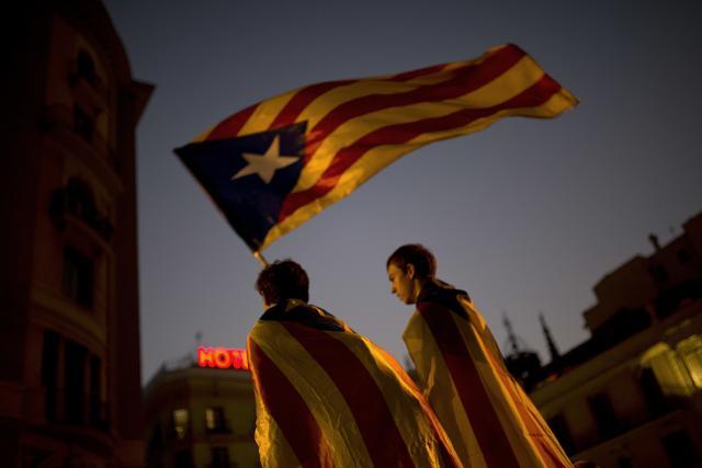 Pro-independence supporters carry an 'Estelada' or independence flag in downtown Barcelona Friday, Oct. 27, 2017. (AP) Pro-independence supporters carry an 'Estelada' or independence flag in downtown Barcelona Friday, Oct. 27, 2017. (AP)