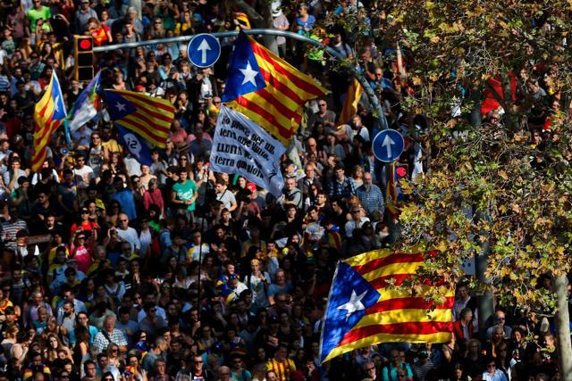 People holding Esteladas gather outside the Catalan parliament in Barcelona. (AFP Photo) People holding Esteladas gather outside the Catalan parliament in Barcelona. (AFP Photo)