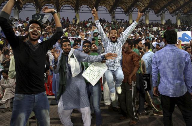 Cricket fans dance during the third Twenty20 international match between Pakistan and Sri Lanka at the Gaddafi stadium in Lahore. (AP) Cricket fans dance during the third Twenty20 international match between Pakistan and Sri Lanka at the Gaddafi stadium in Lahore. (AP)