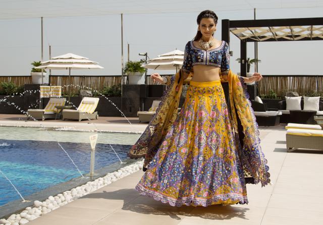 Ditch lehengas that will weigh you and your style down. This contemporary piece brings together floral motifs and the unusual combination of bright yellow and indulgent blue. (Jasjeet Plaha/HT Photo)