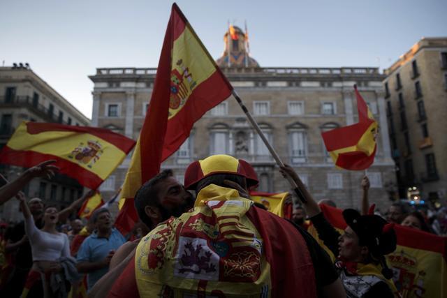 Pro-Spain union demonstrators dance in front of Palau de la Generalitat de Catalunya hours after a rally against Catalonia's declaration of independence, in Barcelona, on October 29, 2017. (AP)
