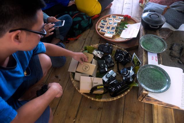 People look through greeting cards and old film cameras that are on display at a once-a-month ex lover's market in Hanoi. (AFP)