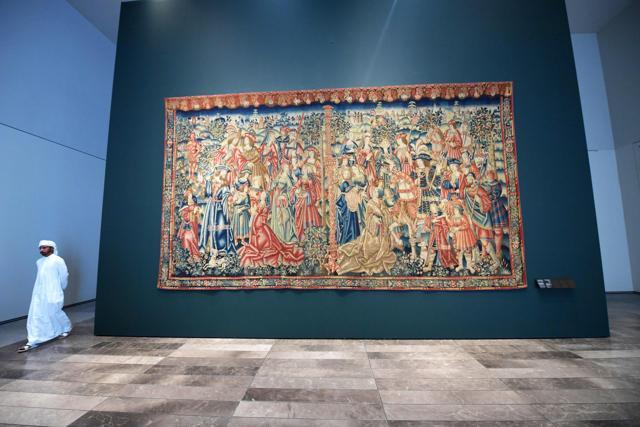 A man walks past the medieval "Tapestry of Daniel and Nebuchadnezzar" displayed at the Louvre Abu Dhabi Museum during a media tour on November 6, 2017, prior to the official opening of the museum on Saadiyat island in the Emirati capital on November 8. (AFP) A man walks past the medieval "Tapestry of Daniel and Nebuchadnezzar" displayed at the Louvre Abu Dhabi Museum during a media tour on November 6, 2017, prior to the official opening of the museum on Saadiyat island in the Emirati capital on November 8. (AFP)
