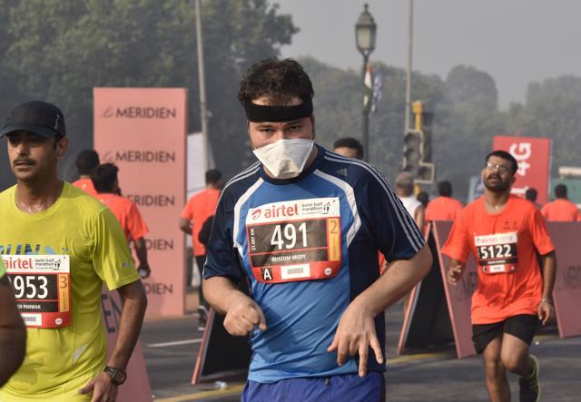 A participant runs during the Airtel Delhi Half Marathon 2016. (Sanjeev Verma/HT PHOTO)