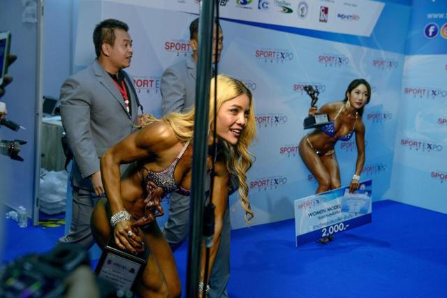 Nittaya Kongthun (L) holds the winning trophy as she exits the stage. (AFP) Nittaya Kongthun (L) holds the winning trophy as she exits the stage. (AFP)
