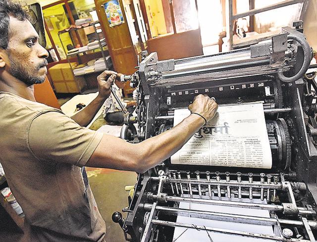 Worker, Umesh, preparing the offset machine for printing the two-page daily newspaper at the press. (Arijit Sen/HT Photo) Worker, Umesh, preparing the offset machine for printing the two-page daily newspaper at the press. (Arijit Sen/HT Photo)