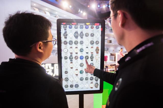 People select watches on an electronic screen at a T-Mall exhibition during the Singles Day shopping festival in Shanghai on November 11, 2017. (AFP) People select watches on an electronic screen at a T-Mall exhibition during the Singles Day shopping festival in Shanghai on November 11, 2017. (AFP)
