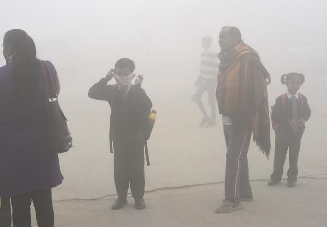 A boy in Delhi uses a handkerchief to cover his face as he waits in the smog for his school bus. (AP Photo/R S Iyer) A boy in Delhi uses a handkerchief to cover his face as he waits in the smog for his school bus. (AP Photo/R S Iyer)
