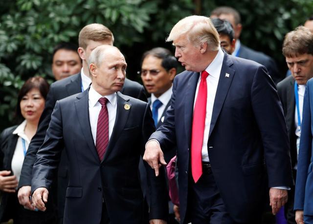US President Donald Trump and Russia's President Vladimir Putin talk during the family photo session at the APEC Summit in Danang, Vietnam November 11, 2017. (REUTERS) US President Donald Trump and Russia's President Vladimir Putin talk during the family photo session at the APEC Summit in Danang, Vietnam November 11, 2017. (REUTERS)