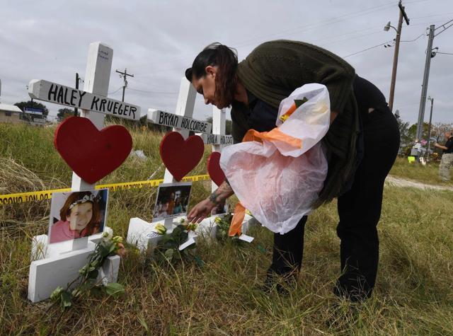 Jessica Mires leaves flowers on crosses named for the victims outside the First Baptist Church, which was the scene of the mass shooting that killed 26 people in Sutherland Springs, Texas on November 9, 2017. (AFP) Jessica Mires leaves flowers on crosses named for the victims outside the First Baptist Church, which was the scene of the mass shooting that killed 26 people in Sutherland Springs, Texas on November 9, 2017. (AFP)