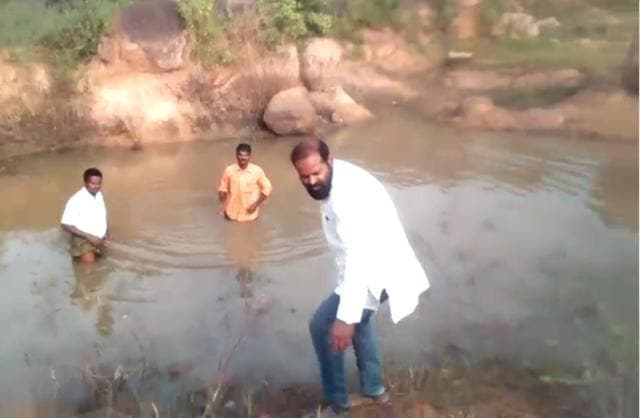 The video clip shows an angry Reddy caning the two men with a stick and hurling abuses. (Screenshot from video) The video clip shows an angry Reddy caning the two men with a stick and hurling abuses. (Screenshot from video)